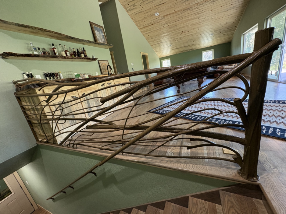 Custom branch-style metal railing overlooking living space